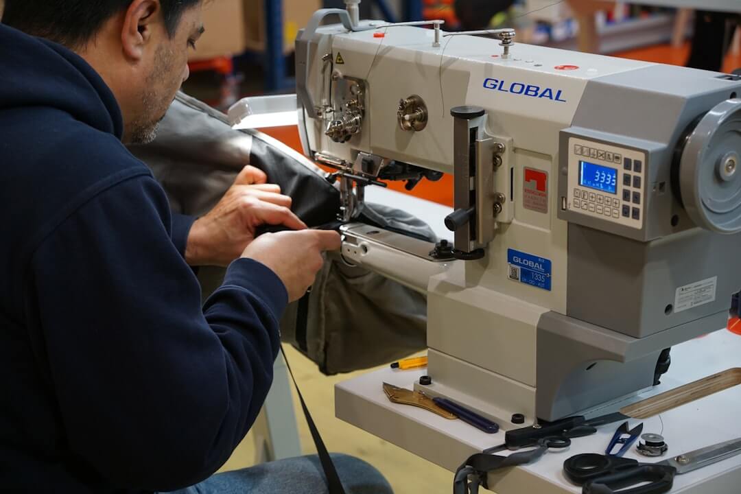 Person operating a sewing machine, demonstrating thoughtful production